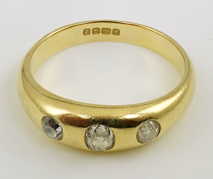 A George V 18ct gold and three stone gypsy set diamond ring